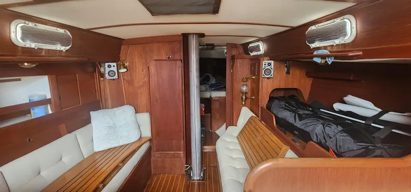 Slide: The Image of Interior of a 1982 Tartan 37 sailboat with wooden furnishings and cozy seating. - 26
