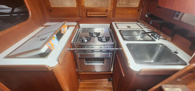Slide: The Image of Compact kitchen in 1982 Tartan 37 sailboat with stove, sink, and storage. - 28
