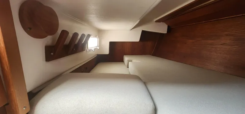Slide: The Image of Interior cabin of a 1982 Tartan 37 sailboat with wooden accents and cushioned seating. - 29