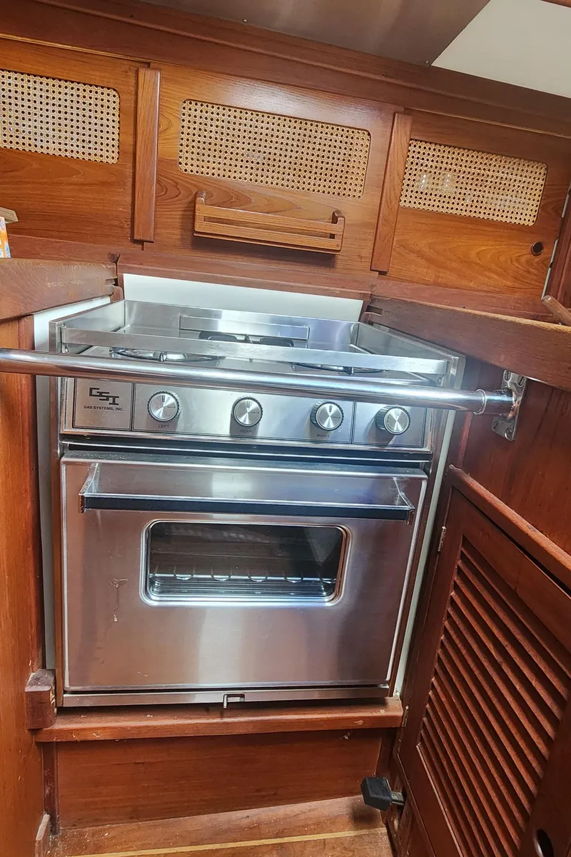 Slide: The Image of Stainless steel stove in 1982 Tartan 37 yacht galley with wooden cabinetry. - 30