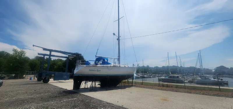 Slide: The Image of 1982 Tartan 37 sailboat on dry dock near marina, under clear blue sky. - 36