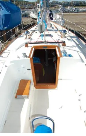 Slide: The Image of 1982 Tartan 37 sailboat deck with open cabin, docked at marina. - 4
