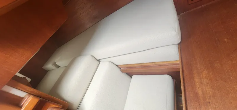 Slide: The Image of Interior cabin of a 1982 Tartan 37 sailboat with white cushions. - 8