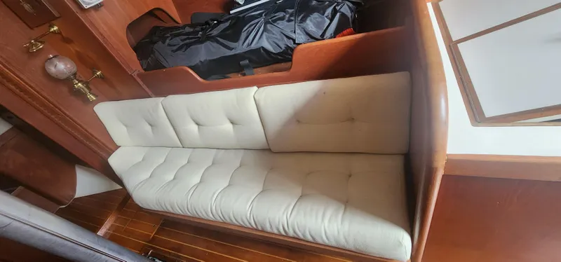 Slide: The Image of Interior of 1982 Tartan 37 sailboat with cushioned seating and wooden accents. - 9