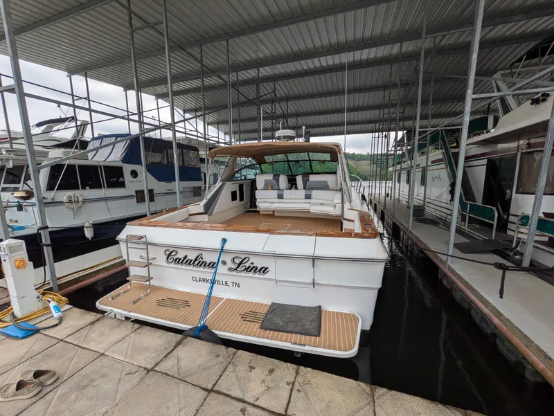 Slide: The Image of 1988 Sea Ray 460 Express Cruiser docked in marina, rear view. - 12