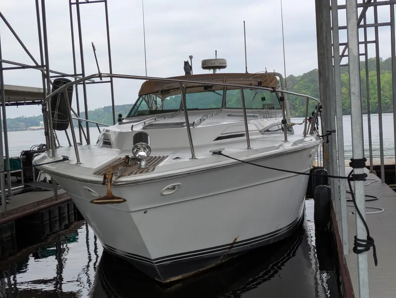 Slide: The Image of 1988 Sea Ray 460 Express Cruiser docked at marina, front view. - 3