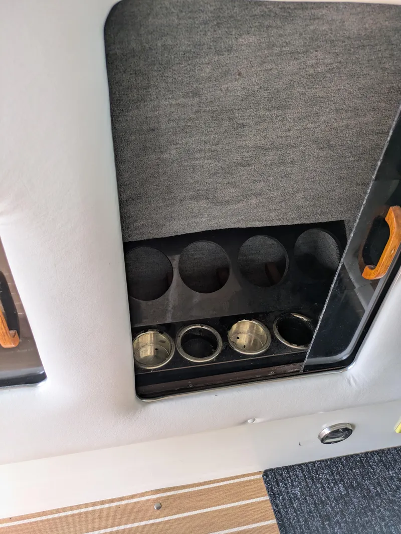 Slide: The Image of 1988 Sea Ray 460 Express Cruiser interior with cup holders and storage compartment. - 39