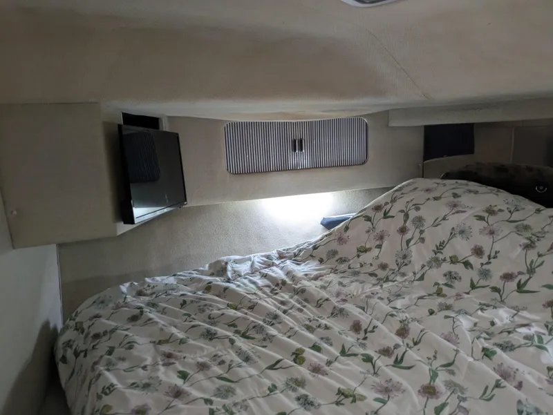 Slide: The Image of Cozy cabin interior of 1988 Sea Ray 460 Express Cruiser with floral bedding. - 41