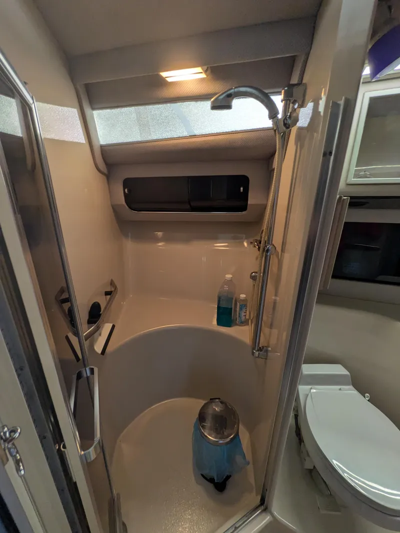 Slide: The Image of Bathroom interior of 1988 Sea Ray 460 Express Cruiser with shower and toilet. - 47