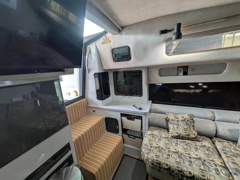 Slide: The Image of Interior of 1988 Sea Ray 460 Express Cruiser with cozy seating and modern amenities. - 48