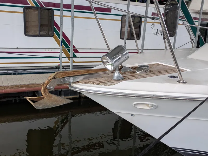 Slide: The Image of 1988 Sea Ray 460 Express Cruiser with anchor and spotlight at dock. - 5
