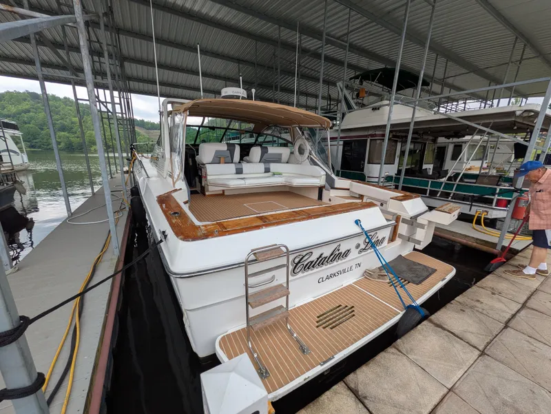 Slide: The Image of 1988 Sea Ray 460 Express Cruiser docked in a covered marina. - 8