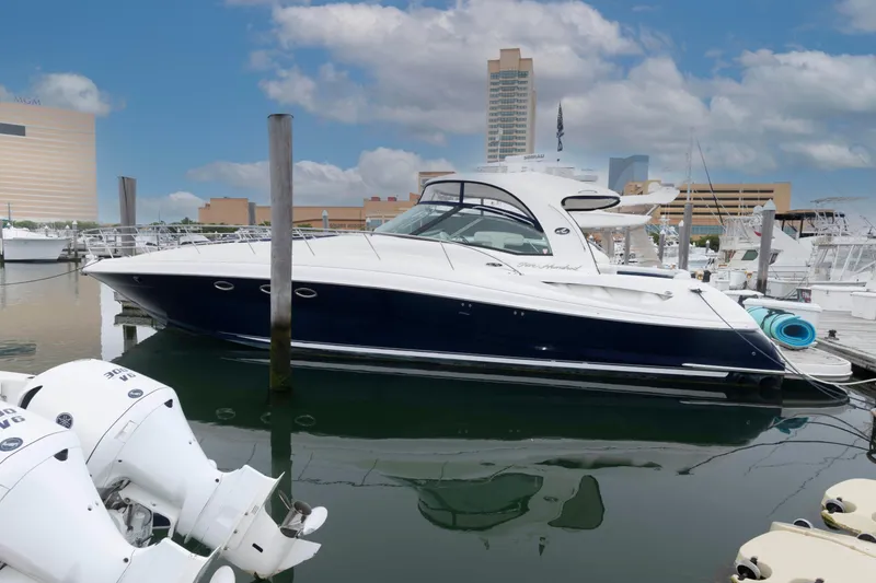 The Image of 2005 Sea Ray 500 Sundancer yacht docked in marina, clear sky background. - 0