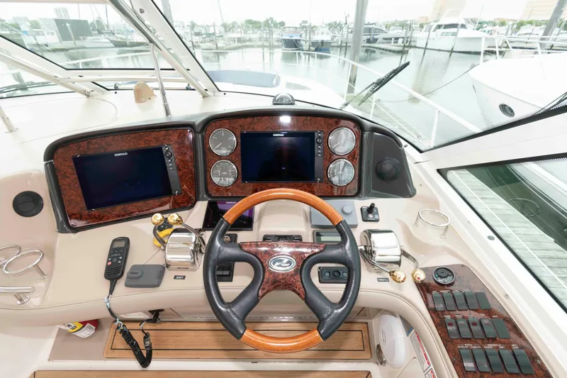 Slide: The Image of Cockpit of 2005 Sea Ray 500 Sundancer with steering wheel and navigation controls. - 10