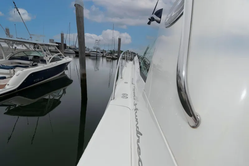 Slide: The Image of 2005 Sea Ray 500 Sundancer yacht docked in a marina, side view. - 14