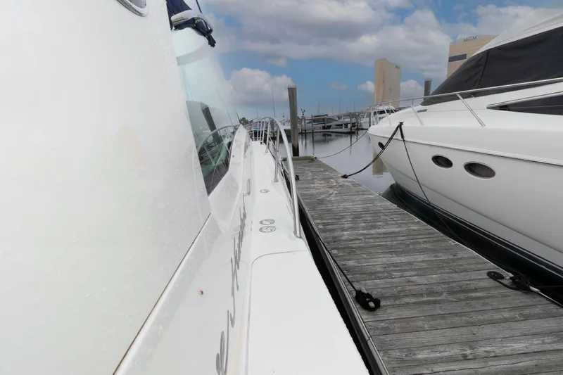 Slide: The Image of 2005 Sea Ray 500 Sundancer yacht docked at marina under blue sky. - 15