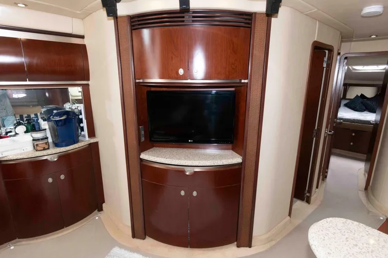 Slide: The Image of Luxurious interior of 2005 Sea Ray 500 Sundancer yacht with wood cabinetry and TV. - 19