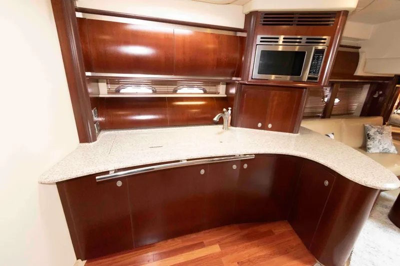 Slide: The Image of Luxurious 2005 Sea Ray 500 Sundancer yacht kitchen with sleek wood cabinetry and modern appliances. - 20