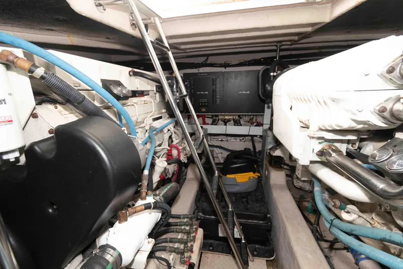 Slide: The Image of Engine room of 2005 Sea Ray 500 Sundancer, showcasing mechanical components and equipment. - 24