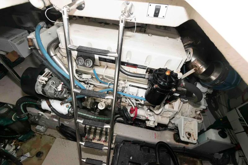 Slide: The Image of Engine room of 2005 Sea Ray 500 Sundancer with visible machinery and ladder. - 26