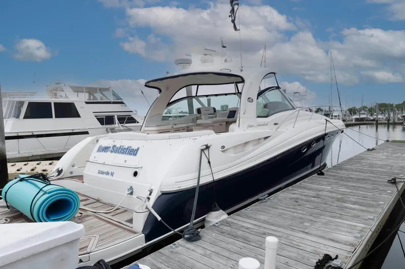 Slide: The Image of 2005 Sea Ray 500 Sundancer yacht docked at marina under blue sky. - 3