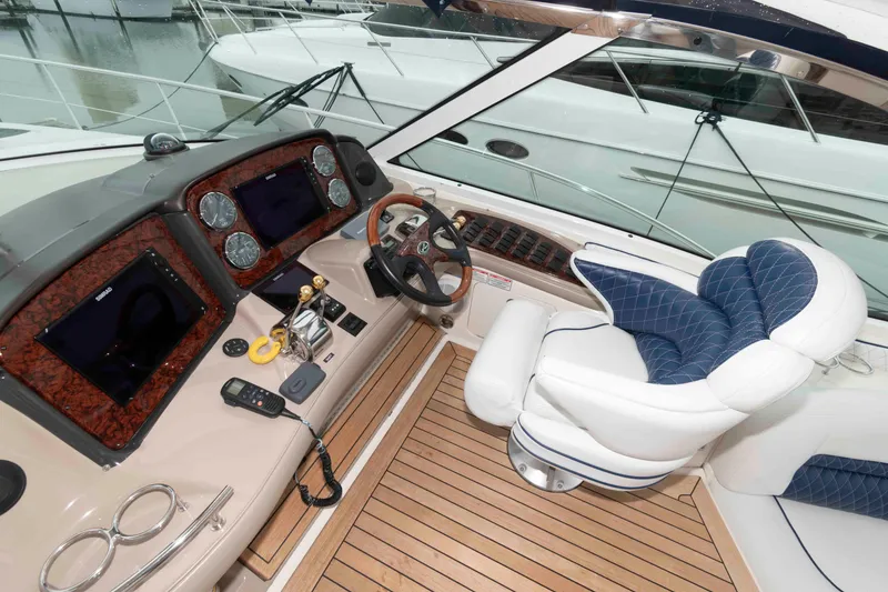 Slide: The Image of 2005 Sea Ray 500 Sundancer helm with luxurious seating and advanced navigation controls. - 8