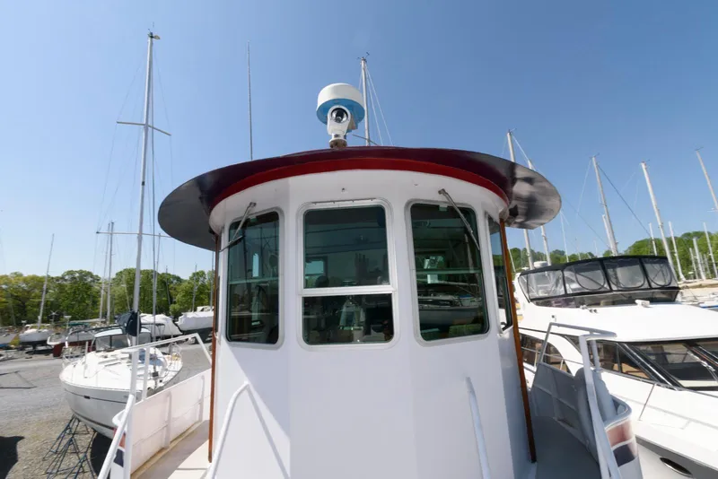 Slide: The Image of 1997 Florida Bay Coasters 35 boat docked among sailboats under clear blue sky. - 10