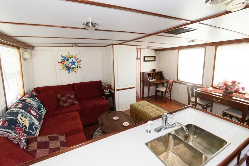 Slide: The Image of Interior of a 1997 Florida Bay Coasters 35 with cozy seating and kitchen area. - 18