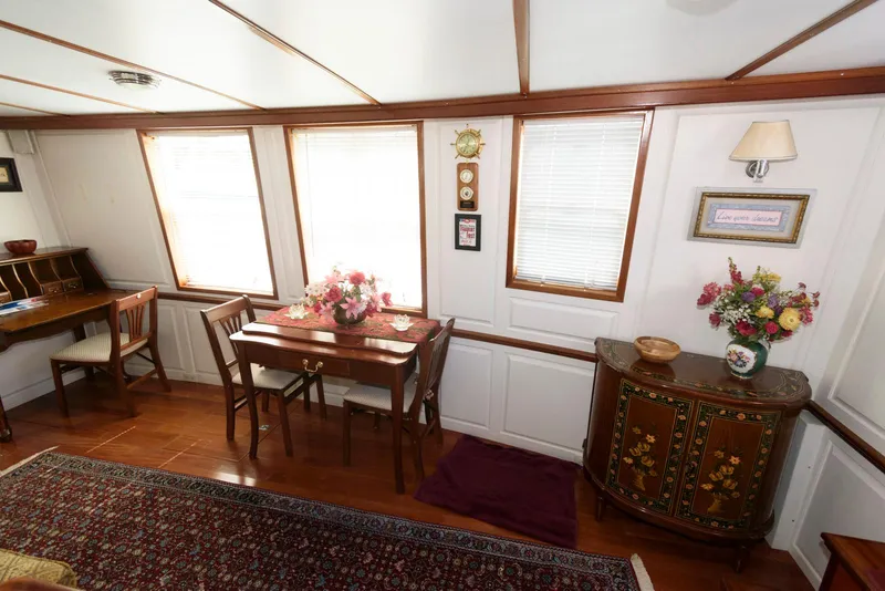 Slide: The Image of Interior of 1997 Florida Bay Coasters 35, featuring elegant dining area with floral decor. - 19