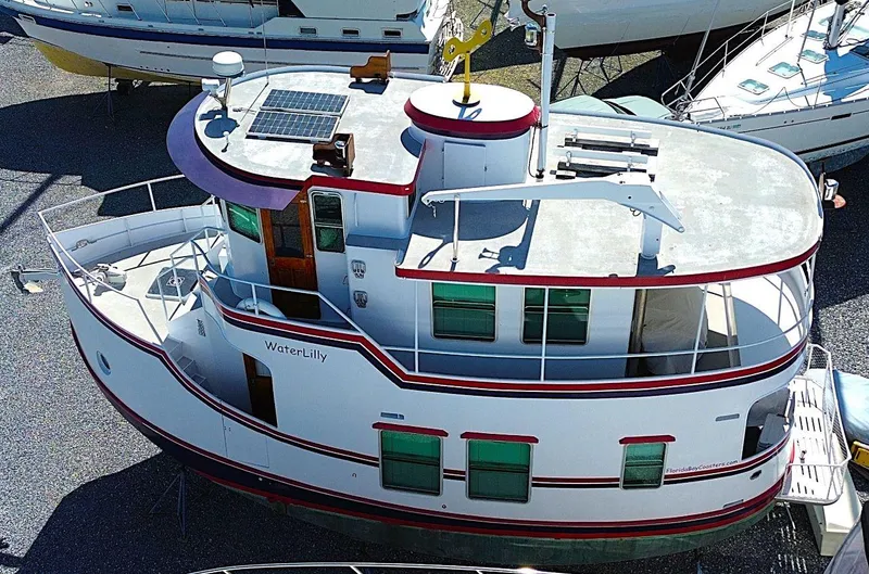 Slide: The Image of 1997 Florida Bay Coasters 35 boat, aerial view, docked, featuring red accents and solar panel. - 2