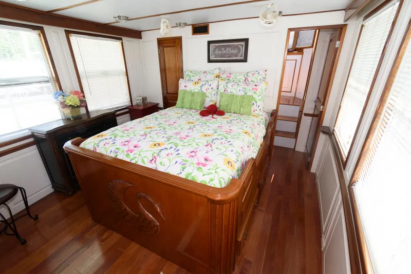 Slide: The Image of Cozy bedroom with floral bedding in a 1997 Florida Bay Coasters 35 houseboat. - 20