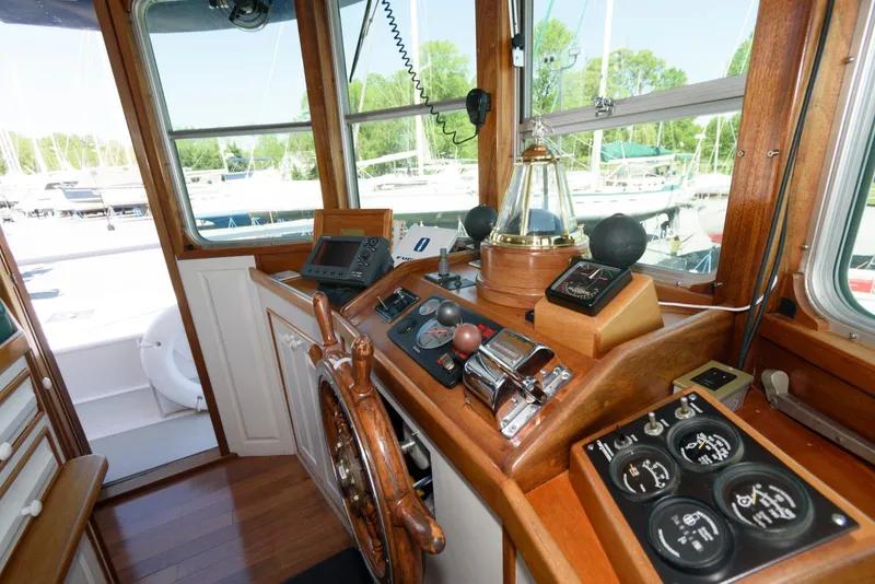 Slide: The Image of Interior helm of a 1997 Florida Bay Coasters 35 boat, featuring classic wooden controls. - 28