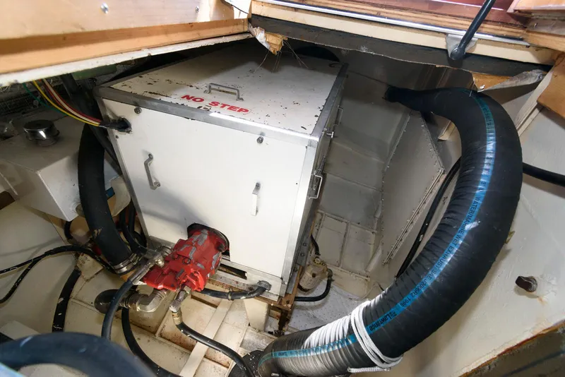 Slide: The Image of Engine compartment of a 1997 Florida Bay Coasters 35 boat, featuring hoses and machinery. - 36