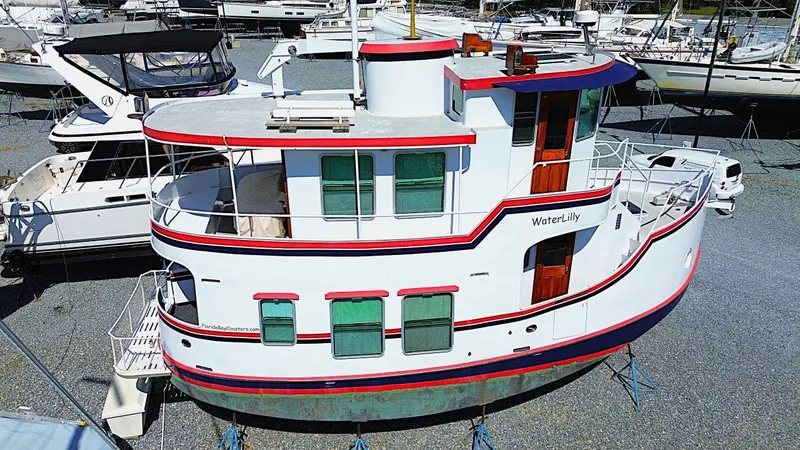 Slide: The Image of 1997 Florida Bay Coasters 35 boat, named "WaterLily," docked in a marina. - 4