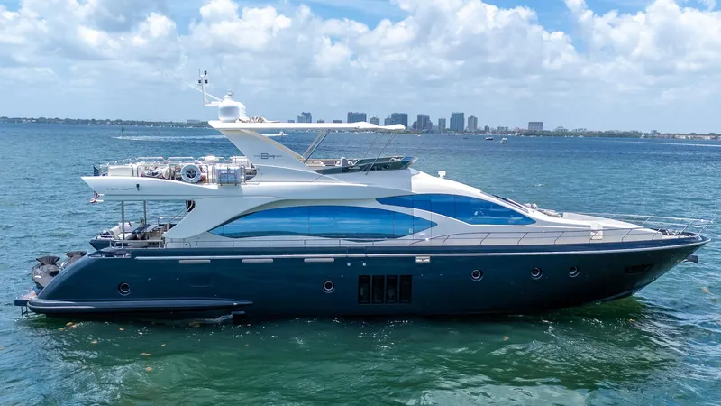 Slide: The Image of 2013 Azimut 84 Flybridge Motor Yacht on open water, city skyline in background. - 1