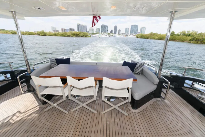 Slide: The Image of Azimut 84 Flybridge Motor Yacht 2013, rear deck view with dining area, city skyline in background. - 12