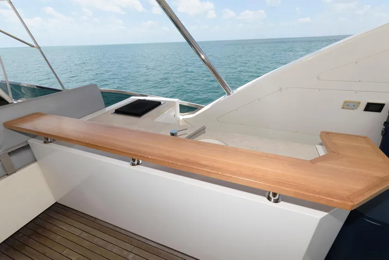 Slide: The Image of Azimut 84 Flybridge Motor Yacht 2013, featuring a sleek wooden deck railing with ocean view. - 34