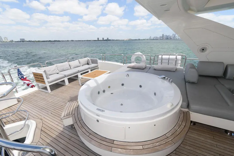 Slide: The Image of Luxurious Azimut 84 Flybridge Yacht with jacuzzi and seating, cruising on open water. - 37