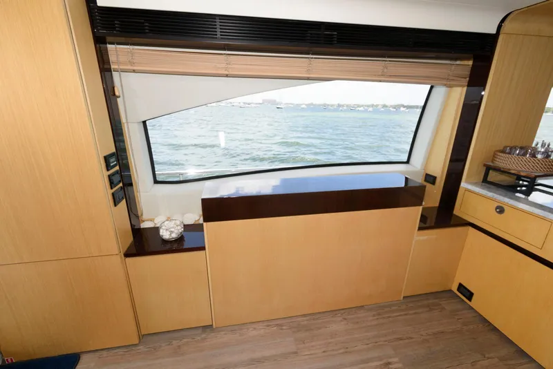 Slide: The Image of Interior view of 2013 Azimut 84 Flybridge Motor Yacht with large window and wooden cabinetry. - 46