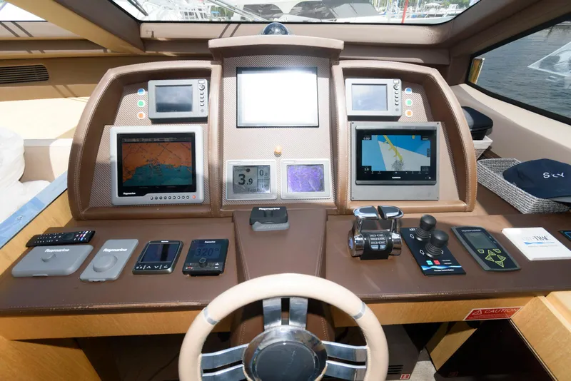 Slide: The Image of Control panel of a 2013 Azimut 84 Flybridge Motor Yacht with navigation screens and controls. - 49