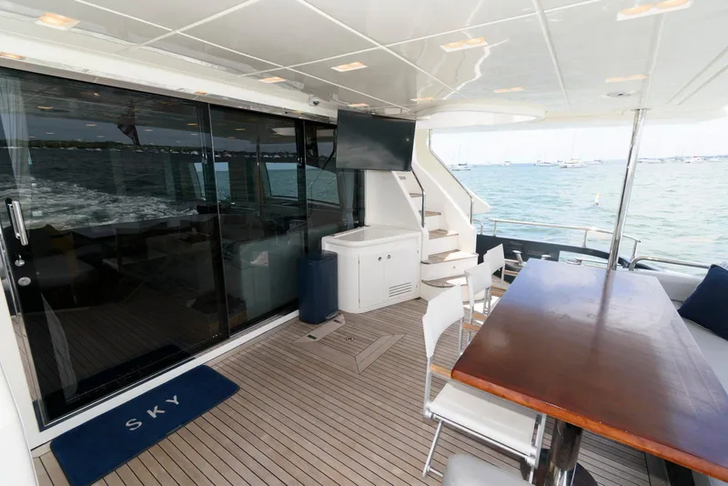 Slide: The Image of Azimut 84 Flybridge Motor Yacht 2013, spacious deck with seating, table, and ocean view. - 9