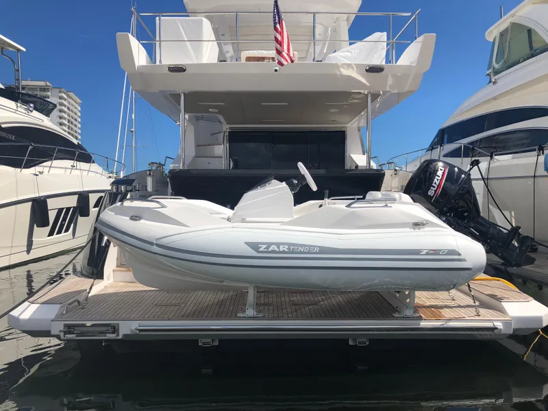 Slide: The Image of Zar Formenti ZF-0 boat, 2025 model, docked with American flag, sunny day. - 3