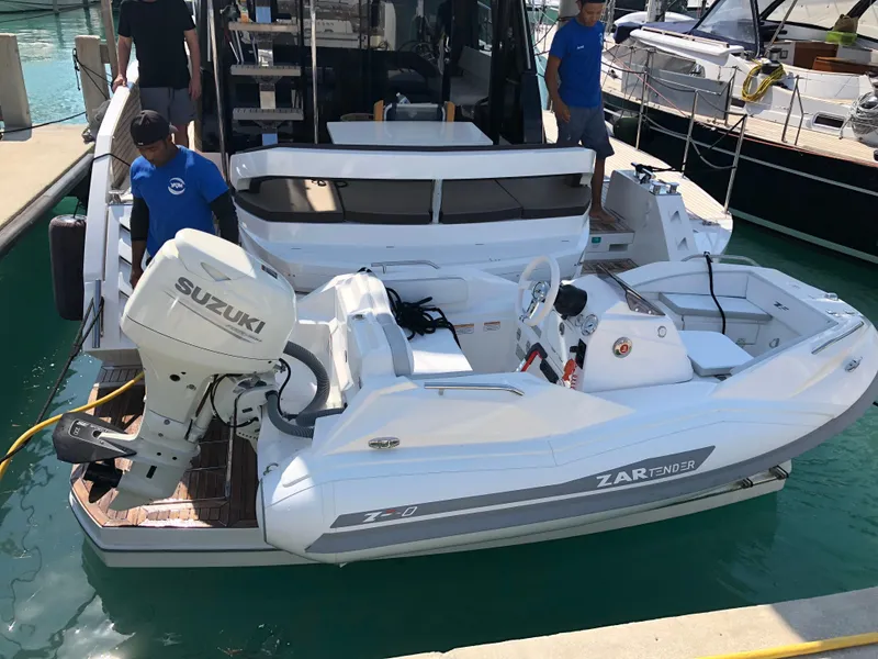 Slide: The Image of 2025 Zar Formenti ZF-0 boat docked, featuring Suzuki outboard motor, with crew onboard. - 4