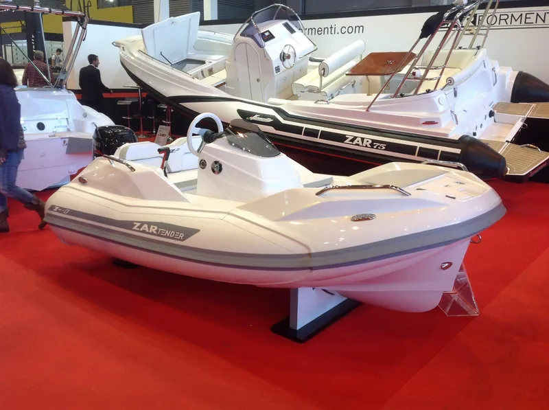 Slide: The Image of 2025 Zar Formenti ZF-0 boat displayed on red carpet at a boat show. - 5