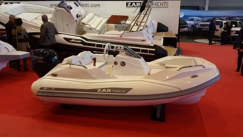 Slide: The Image of 2025 Zar Formenti ZF-0 boat displayed at an indoor exhibition on a red carpet. - 6