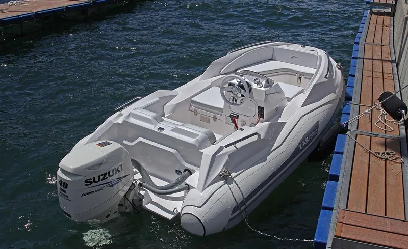 Slide: The Image of 2025 Zar Formenti ZF-1 boat docked, featuring Suzuki outboard motor. - 12