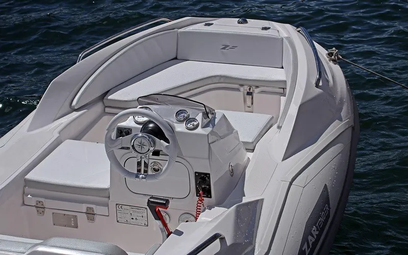 Slide: The Image of Zar Formenti ZF-1 2025 boat interior with steering wheel and seating on water. - 13