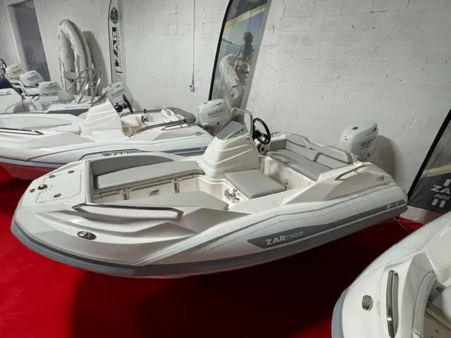 Slide: The Image of 2025 Zar Formenti ZF-2 boat displayed indoors on red carpet. - 16