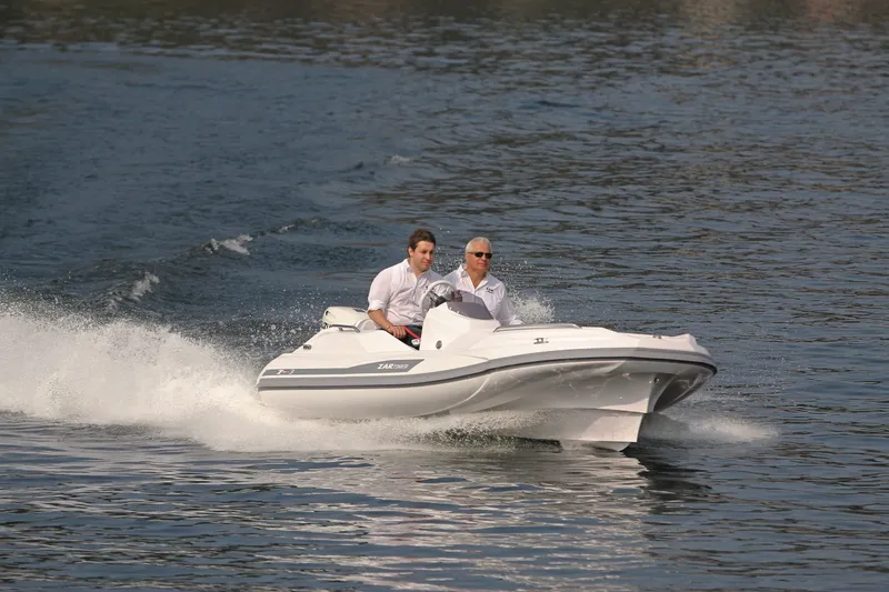 Slide: The Image of Two people riding a 2025 Zar Formenti ZF-3 boat on water. - 2