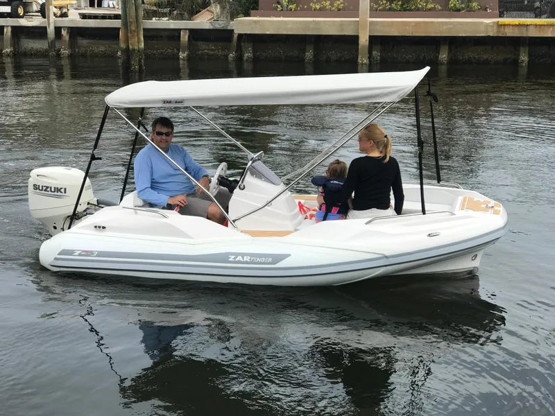 Slide: The Image of Family enjoying a ride on a 2025 Zar Formenti ZF-3 boat with Suzuki engine. - 4